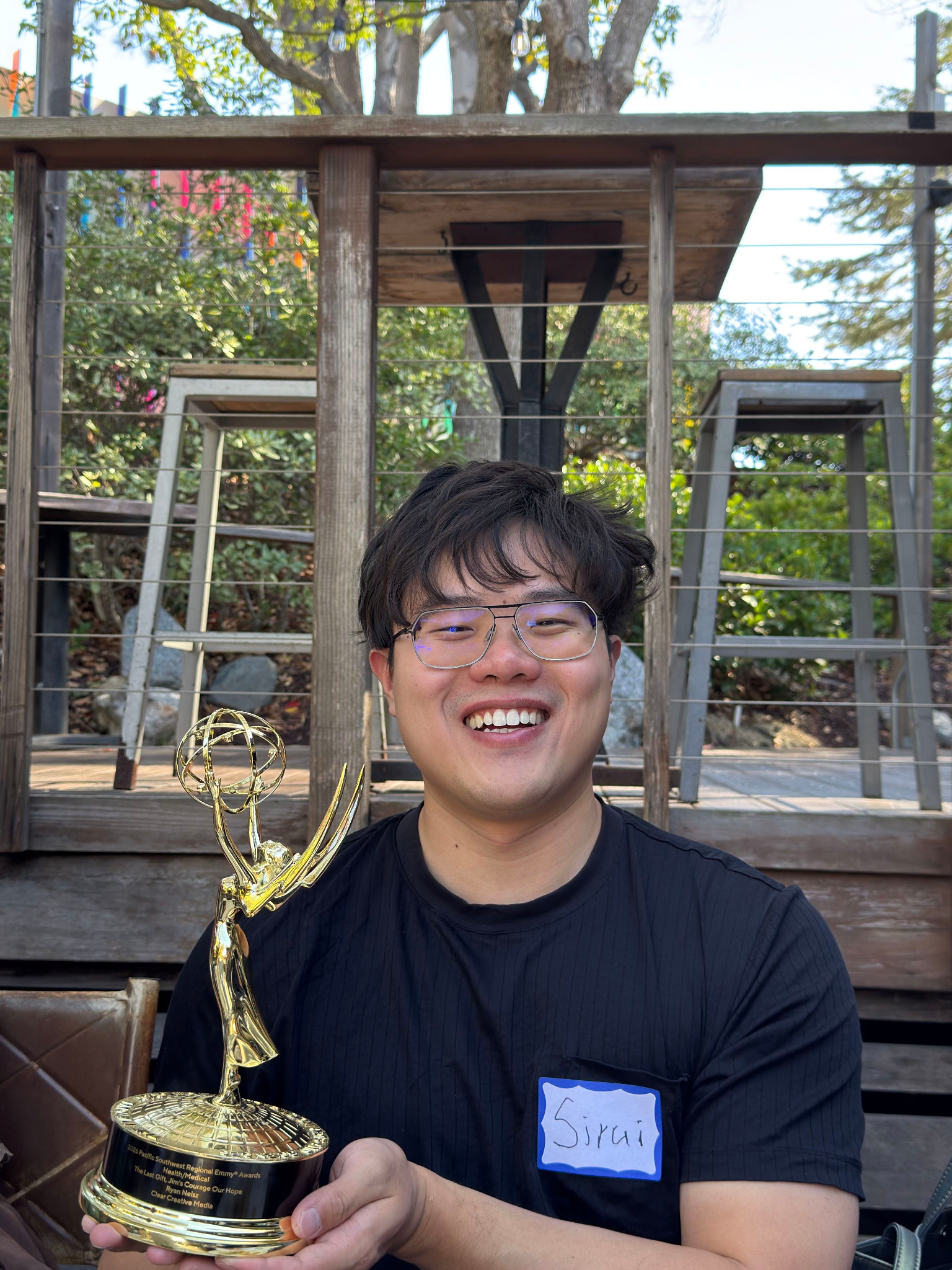 Sirui holding The Last Gift's Pacific Southwest Emmy at the Design Lab retreat on October 16, 2026